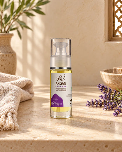 Huile d'Argan Lavande 30 ml sur une étagère en pierre claire, avec un brin de lavande, sous une douce lumière naturelle.