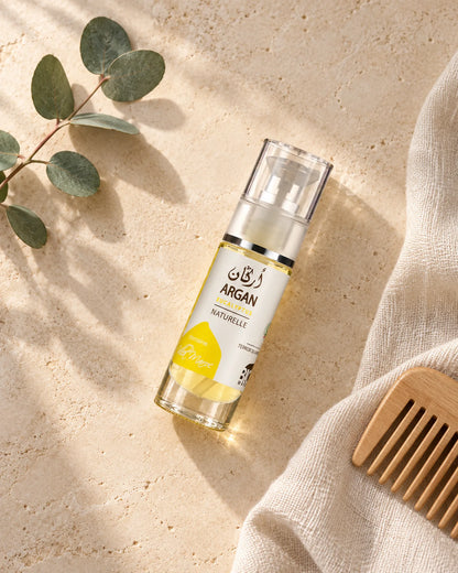 Huile d'Argan et d'Eucalyptus 30 ml — vue du dessus dans une salle de bain marocaine à la lumière naturelle.
